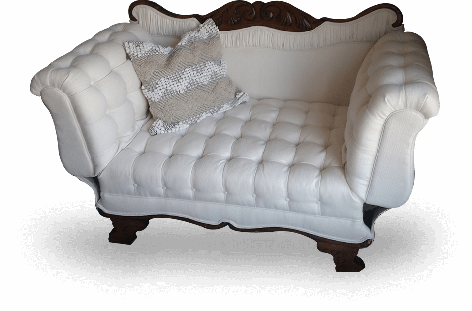 A white couch with pillows on it
